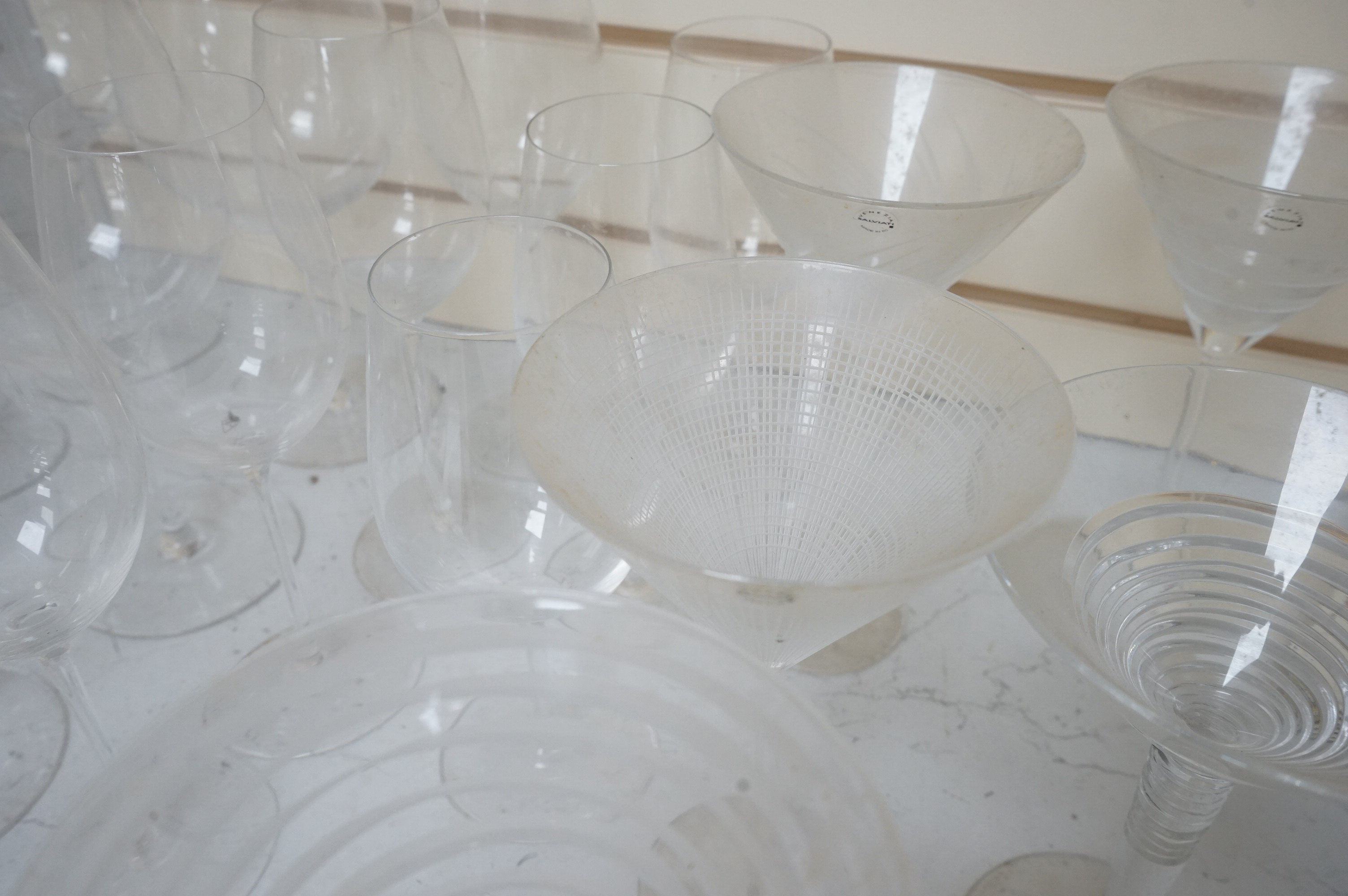 A Pierre Frey ‘Gonesse’ Limoges part dinner service, two Villeroy and Boch ‘Jardins Francais’ dinner plates, with a collection of Riedel wine glasses and mixed Salviati champagne glasses. Villeroy and Boch plates 30.5cm